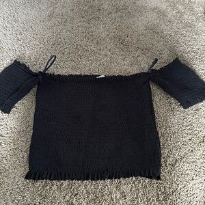 A black top color black shoulder top